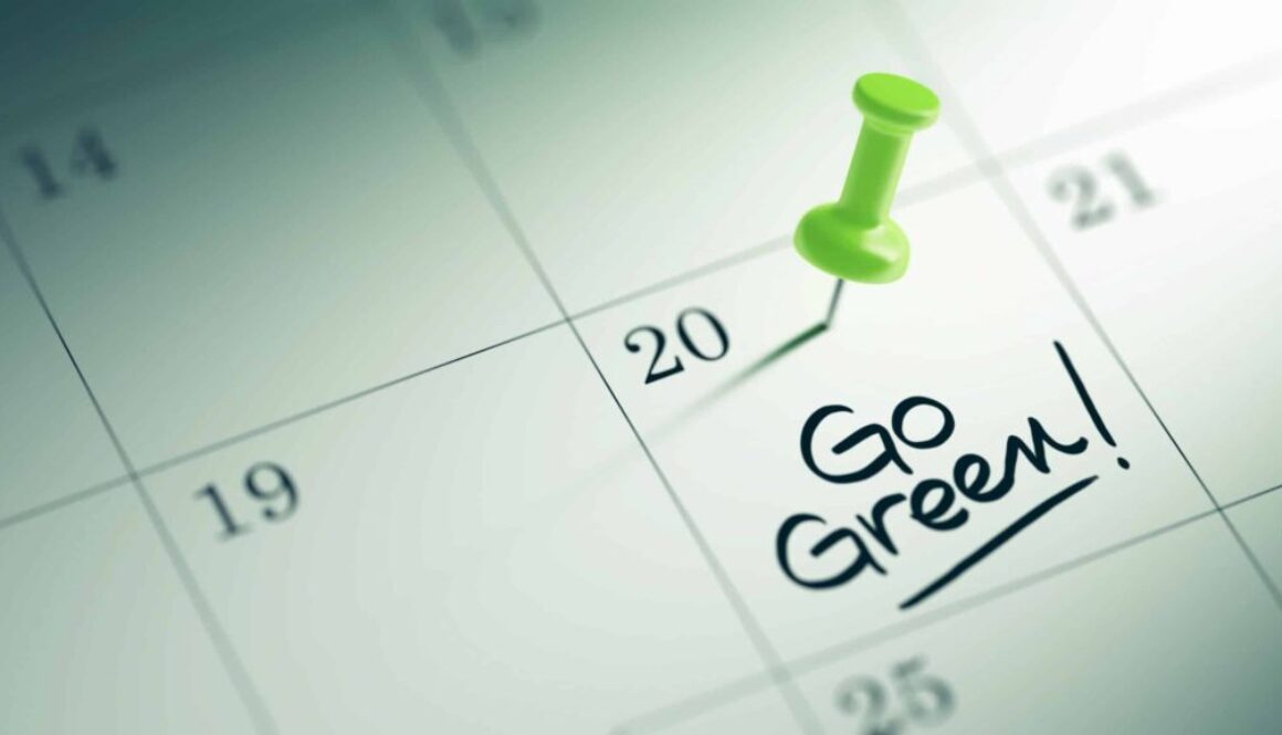 Concept image of a Calendar with a green push pin. Closeup shot